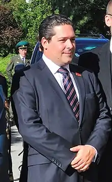 George, aged 29, in suit and tie