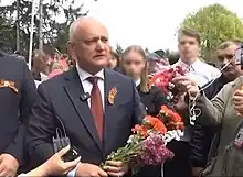 Moldovan former president Igor Dodon (wearing the Ribbon of Saint George) with members of the Șor Party at a Victory Day rally on 9 May 2023