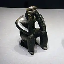 The Thinker; by Hamangia culture from Romania; c. 5000 BC; terracotta; height: 11.5&nbsp;cm (4.mw-parser-output .frac{white-space:nowrap}.mw-parser-output .frac .num,.mw-parser-output .frac .den{font-size:80%;line-height:0;vertical-align:super}.mw-parser-output .frac .den{vertical-align:sub}.mw-parser-output .sr-only{border:0;clip:rect(0,0,0,0);clip-path:polygon(0px 0px,0px 0px,0px 0px);height:1px;margin:-1px;overflow:hidden;padding:0;position:absolute;width:1px}1⁄2 in.); National Museum of Romanian History (Bucharest)