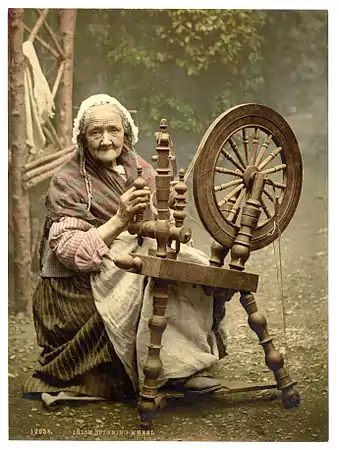 A photochrom of an elderly Irish woman using a spinning wheel, Co. Galway, Ireland, c. 1890s