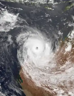 Satellite image of a powerful cyclone near the coast of Western Australia. The storm is very mature, with a large area of deep thunderstorms and a well-defined, clear eye.