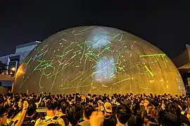 Protesters shining laser lights on the exteriors of the Hong Kong Space Museum, August 2019