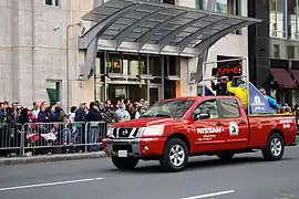 The entrance to Mandarin Oriental, Boston as a pace truck for the 2013 Boston Marathon passes by.
