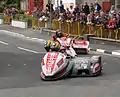 2013 Isle of Man TT&nbsp;Sidecar Race 1&nbsp;— Lap 3 Tim Reeves/Dan Sayle (3) & Dave Molyneux/Patrick Farrance (1) Parliament Square, Ramsey 1 June 2013.