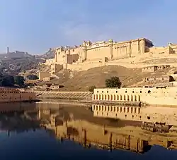 Amber Fort as seen from the bank of Maotha Lake, Jaigarh Fort on the hills in the background