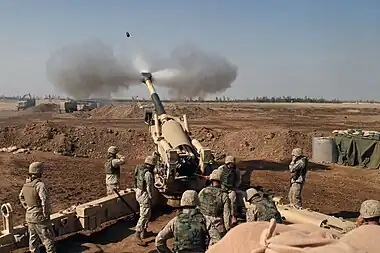 Image 14M198 howitzerPhoto credit: L Cpl. Samantha L. Jones, USMCNine Marines from Mike Battery, 4th Battalion, 14th Marines operate the 155mm M198 howitzer in November 2004. The battery was based at Camp Fallujah, Iraq and was supporting Operation Phantom Fury. All nine members of the M198 crew are present.More selected pictures