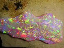 Brazilian Crystal Opal. The play of color is caused by the interference and diffraction of light between silica spheres (150 - 300&nbsp;nm in diameter).