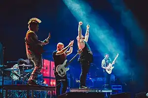 Atreyu performing in 2022. From left to right: Dan Jacobs, Marc McKnight, Brandon Saller, Travis Miguel, and Kyle Rosa.