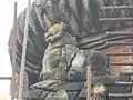 A broken statue of a lion carved on the top of Yameswar Temple