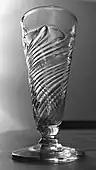 A mid-18th century flammiform (flame-like gadrooning) dwarf ale glass.
