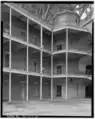 A view toward the southwest corner of the interior, showing the octagonal wooden structure atop the southwest circular staircase.