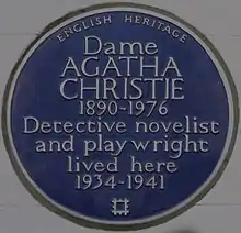 Colour photograph of a wall plaque stating Christie "lived here 1934–1941"