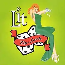 A young red-haired woman in a green dress does a pose while sitting on a big pair of dice.