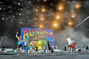 Alestorm performing in 2018. From left to right: Máté Bodor, Elliot Vernon, Gareth Murdock, Peter Alcorn, and Christopher Bowes.