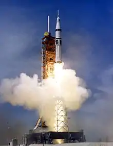 A rocket lifts off to clear blue skies.
