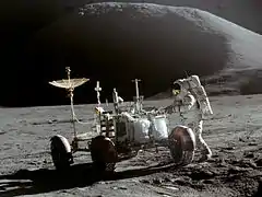 Astronaut works on the Moon at the lunar rover