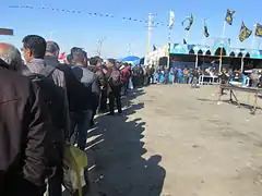 Arba'een pilgrims waiting for receiving free food from mawkibs
