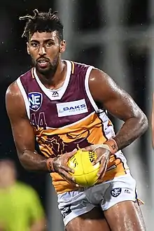 Archie Smith in 2019 as 202 cm (6 ft 8 in)  Brisbane Lions ruck is the son of NBA basketballer Andre Moore