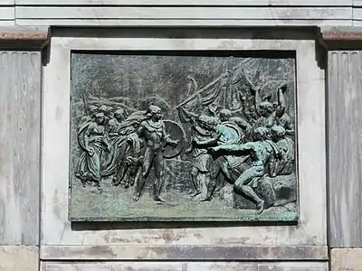The relief on one side of the plinth.
