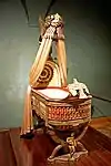 King of Rome's Cradle; by Pierre-Paul Prud'hon, Henri Victor Roguier, Jean-Baptiste-Claude Odiot and Pierre-Philippe Thomire; 1811; wood, silver gilt, mother-of-pearl, sheets of copper covered with velvet, silk and tulle, decorated with silver and gold thread; height: 216&nbsp;cm; Kunsthistorisches Museum (Vienna, Austria)