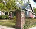 389 Norton Parkway at Goffe Terrace (1908), gate cottage with pier and tile beaver plaque.