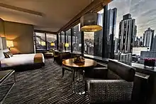Spacious junior suite with 1 King bed and corner windows with city views inside the Bentley Hotel NYC