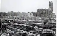On the background the ruins of the Church of Our Lady of Good Counsel at Bezuidenhoutseweg (street)