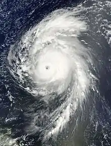 Satellite image of a mature hurricane over the open Atlantic displaying several characteristics of an intense hurricane, including an eye at the center and large spiraling rainbands