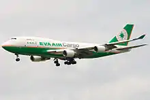 Double-deck aircraft in flight, with deployed landing gear.