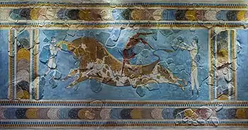 Fresco of an acrobat straddling a bull, with two helpers