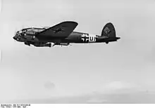 A Heinkel He 111 (code marking 1H DN) of KG 26 with an SC 1000 bomb suspended from its fuselage in March 1941.