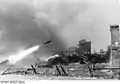 A 28/32&nbsp;cm rocket in flight during the Warsaw Uprising, with piles of spent cases on the right