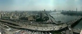 The 6th October Bridge, ramps, and Nile; with Downtown Cairo and Egyptian Museum (on left), in view north from Hilton tower