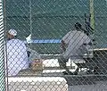 Detainees sit around the exercise yard in Camp 4, the medium security facility within Camp Delta at Naval Station Guantanamo Bay, Cuba. In Camp 4, highly compliant detainees live in a communal setting and have extensive access to recreation.