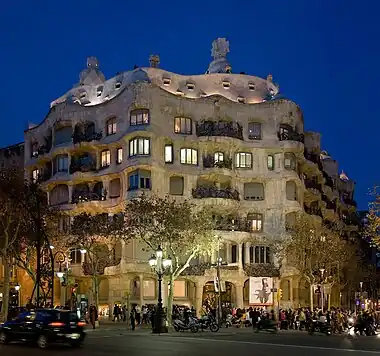 Image 12Casa MilàPhoto credit: David IliffThe Casa Milà, a 1912 work by Catalán architect Antoni Gaudi, in the Eixample district of Barcelona, Spain. Gaudí's fascination with trencadís-influenced decoration and curves (predating biomorphism by almost 20 years) can be seen here.More selected pictures