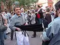 Casteller putting on a faixa