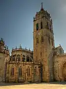 View with the bell tower and the Gothic-style rear, featuring buttresses.