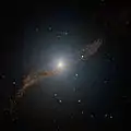 Image of the central parts of Centaurus A showing the parallelogram-shaped remains of a smaller galaxy that was absorbed about 200 to 700 million years ago