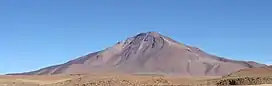 A brown mountain in a barren landscape