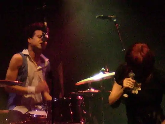 Charley Drayton (left) Chrissy Amphlett (right) on stage with Divinyls