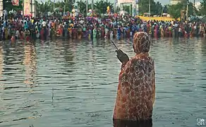 A woman praying during Chhath