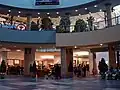 The centre court and food court of Chinook Centre before renovations from the lower level on July 23, 2006, showing Club Monaco, Yogen Fruz, and an HMV poster.