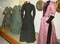 Display of four Victorian dresses.