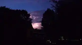 A freeze-frame of a Cumulonimbus cloud in the distance exposing a flash of lightning
