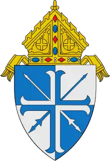 The arms of the Diocese of Lansing: The lances crossed per saltire are a play on the name of the see, the city of Lansing, Michigan.