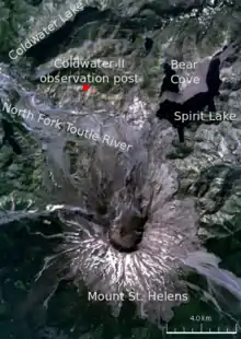 Satellite image of the area surrounding Mount St. Helens, labeled with various locations. The primary locations marked are: Mount St. Helens (in the center of the volcano there is a circular black crater); and to the north of the volcano the Coldwater&nbsp;II observation post, where Johnston was camped. The other locations marked are three lakes (Spirit Lake, Bear Cove, and Coldwater lake) and a river (North Fork Toutle River).