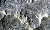 Columbus Crater Layers, as seen by HiRISE. This false-color image is about 800 feet across. Some of the layers contain hydrated minerals.