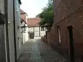 Entrance from beside Sidbury Gate, leading to the south front of the Great Hall 1470