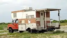 Recreational vehicle customized for beach driving and surf fishing.