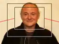 For moving images, the action of zooming in to fill the frame with the subject requires the simultaneous tilting up of the camera, shown by the red lines, to maintain the correct amount of headroom. Conversely, zooming out requires tilting down.